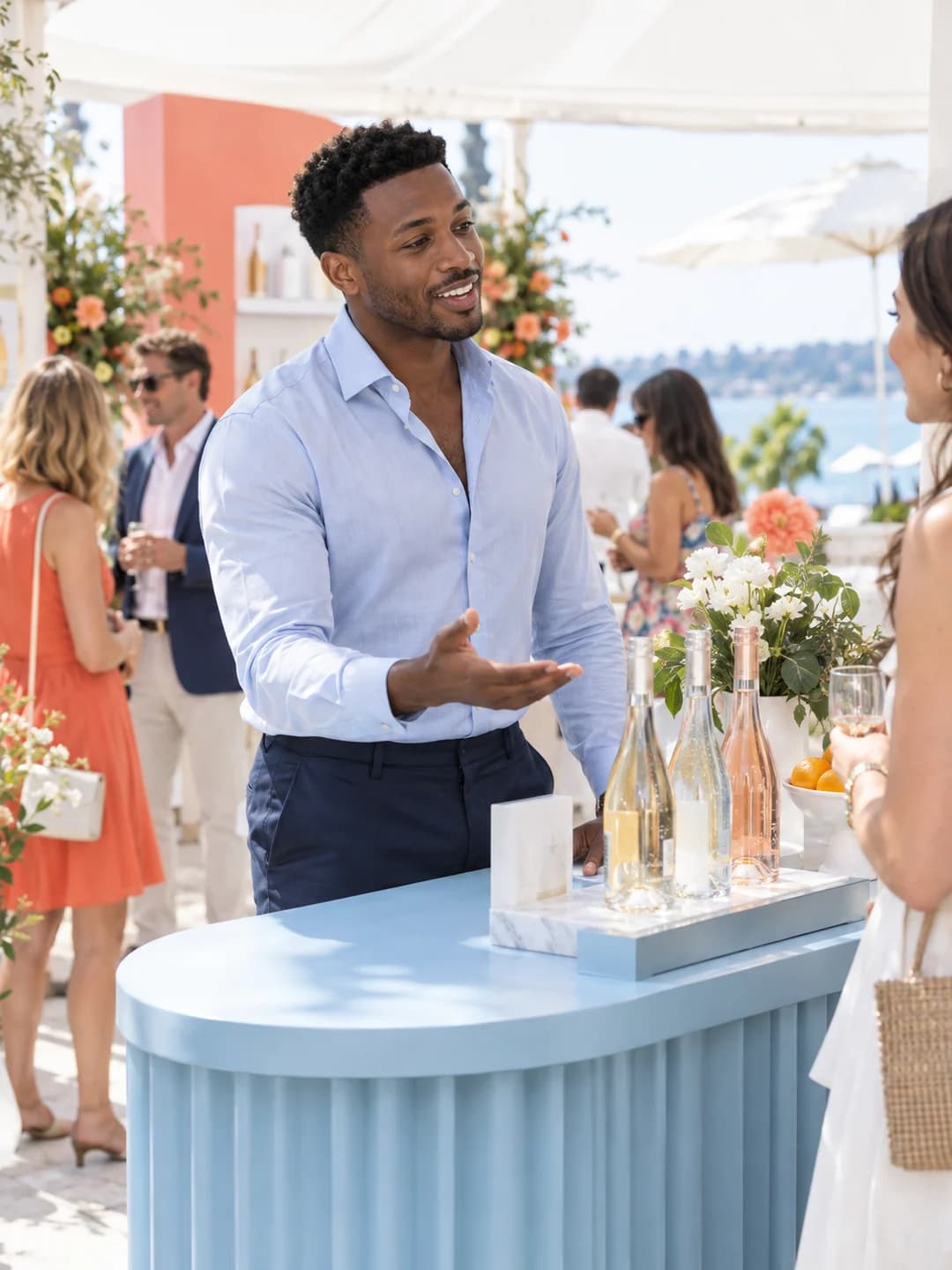 A brand ambassador in a pale blue shirt welcoming a guest at a pop-up